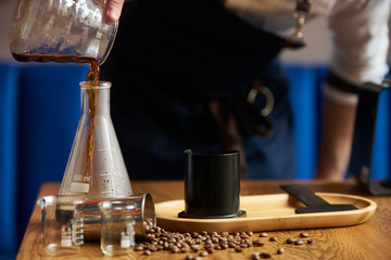 Professional barista preparing coffee alternative method, close-up