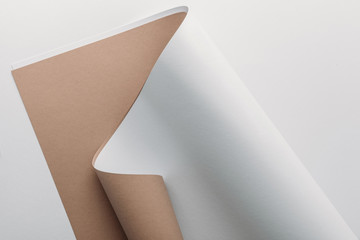 white and brown paper sheets on grey background