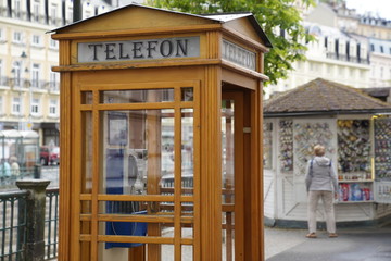 Fototapeta na wymiar Phone booth made out of wood in Carlsbad (Karlovy Vary), Czech Republic