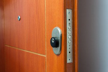 Open door of a family home. Close-up of the lock an armored door. White background.