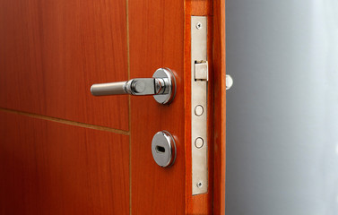 Obraz premium Open door of a family home. Close-up of the lock an armored door.