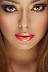 beautiful woman with fashion bright makeup of eyes and glossy pink lips