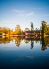 Obraz premium Tree Reflection in the Lake on a Sunny Spring Day - Autumn Colours