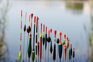 Fishing floats in different shapes on blurred background