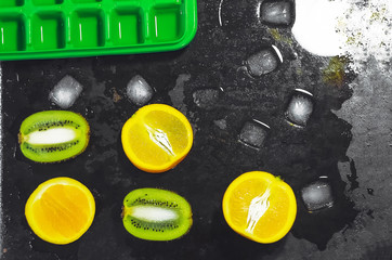 ice melts. ice cubes. sliced fruit. orange and kiwi fruit. Form for ice