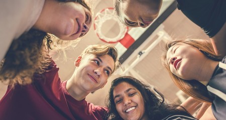 Group of teenager friends on a basketball court teamwork and togetherness concept