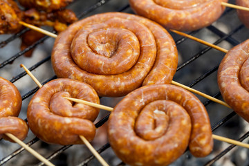 Spiral pork sausage on barbeque grill