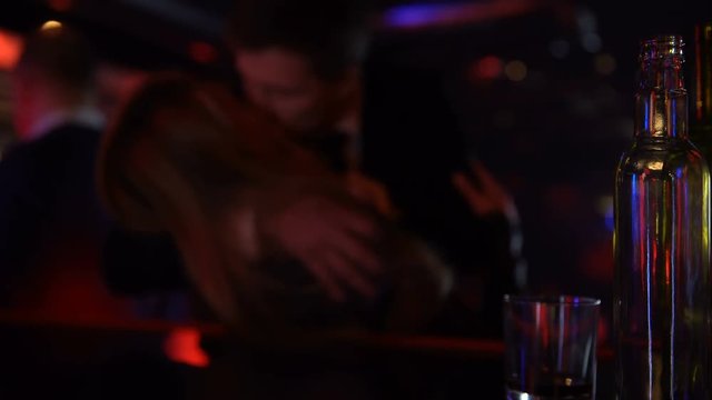 Casual acquaintance in bar, man kissing woman after some whiskey, risk of sti