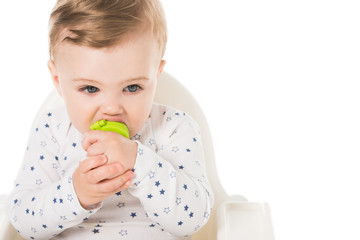 little boy with baby pacifier sitting in highchair isolated on white background