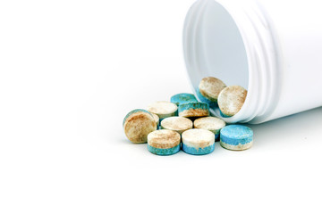 Blue & white pills medicine the drug expired.on white background / Do not use it strictly / very dangerous /  healthy eating for bad life.