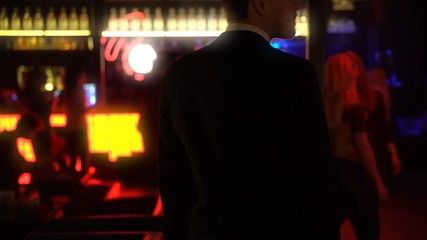 Official waiting for business partner impatiently, closed meeting in elite club