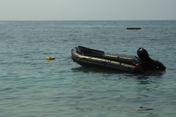 Rescue Boat in the seaof rescue unit to take care of tourist in the sea,Empty black rubber boat and...