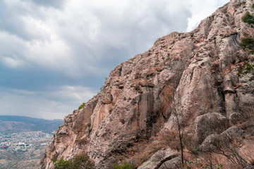 Big rock wall with cloudy sky 