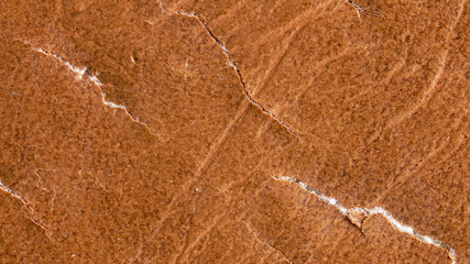 Brown leather material with cracks as background
