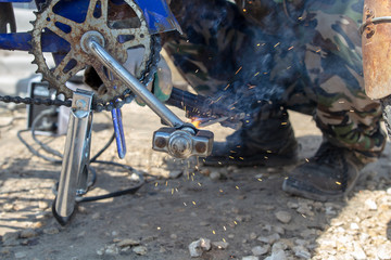 Welder brews the pedal on a bicycle