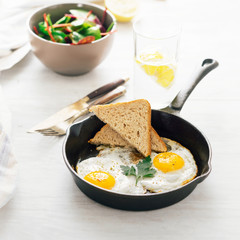 Fried eggs frying pan white wooden table Healthy breakfast concept