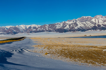  The frozen Sailimu lake with snow mountain background at Yili, Xinjiang of China.