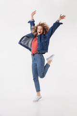 Full length image of Happy curly woman in denim clothes