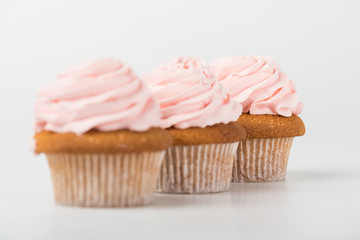 tasty cooked pink cupcakes on white
