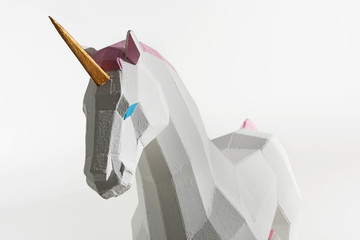 unicorn toy with golden horn isolated on white © LIGHTFIELD STUDIOS