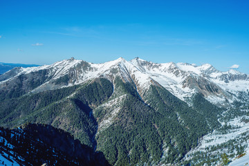 Landscape of snow-capped peaks of the rocky mountains in Sunny weather. Concept of nature and travel