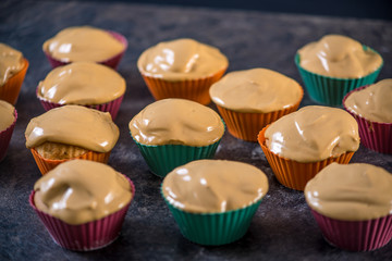 Homemade freshly made cupcakes in silicone molds on dark background. Concept of confectionery cooking