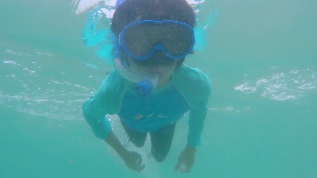 Girl with snorkel mask dive underwater with fun in sea