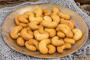 Salted Flavor Roasted Cashew Nut Snacks Served in Plate Also Know as in India Kaju Namkeen or Masala Kaju on Vintage Background