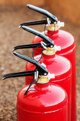  fire extinguishers close up - obrazy, fototapety, plakaty