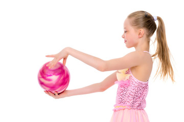 little girl is engaged in fitness with a ball.