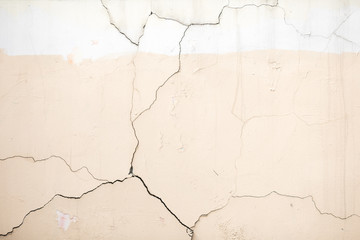 treshiny on the wall, old stucco, texture