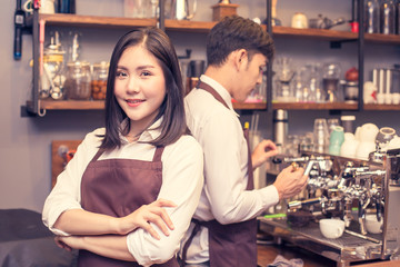 Asian female barista making coffee in coffee shop counter.  Barista female working at cafe. Woman working with small business owner or sme concept. Vintage tone.