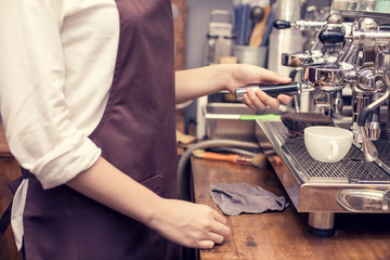 Barista using machine for make coffee at cafe. Vintage tone.