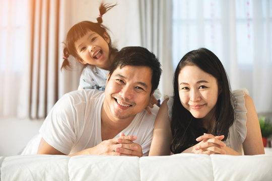 Happy asian family father mother with daughter looking camera with smile face.