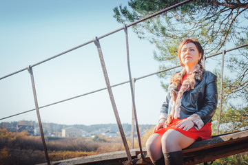 Woman on the suspension bridge in autumn