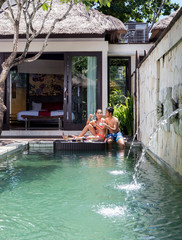 Couple having romantic breakfast in swimming pool,tropical resort