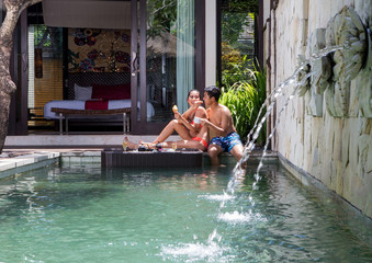 Couple having romantic breakfast in swimming pool,tropical resort