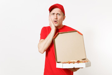 Delivery shocked man in red uniform isolated on white background. Male pizzaman in cap, t-shirt working as courier or dealer holding italian pizza in cardboard flatbox. Spreading hands. Copy space.