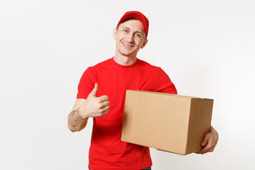 Delivery young man in red uniform isolated on white background. Male in cap, t-shirt, jeans working as courier or dealer holding empty cardboard box. Receiving package. Copy space for advertisement.