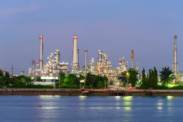 Oil refinery at the river in sunset time / Big Factory in sunrise time