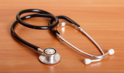 Medical diagnostic tool, stethoscope, on background of table