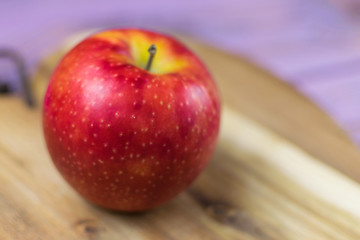 Fresh red apple on a wooden background.