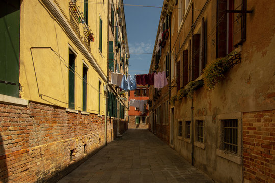 A typical narrow alley in Venice. The residents hung laundry over the street.