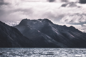 Fototapeta na wymiar Stunning dramatic landscape photo of a beautiful lake Alps mountain at lake Wakatipu.