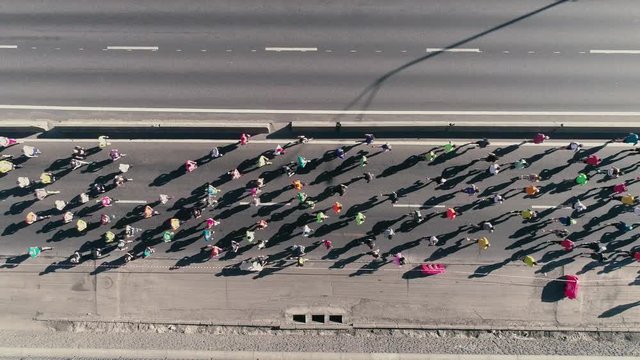 4K Aerial drone fooage. Marathon running on street. Top view