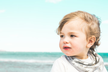 Portrait of a lovely little girl on the beach