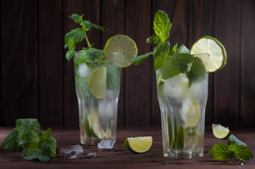 Mojito drink on dark wooden background