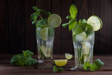 Mojito drink on dark wooden background