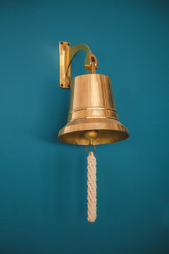 Close-up Of Ship Bell On A Dark Wall