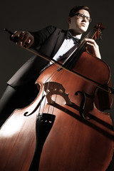 Double bass player contrabass playing. Classical musician © Alenavlad